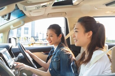 a woman touching a car navigation system