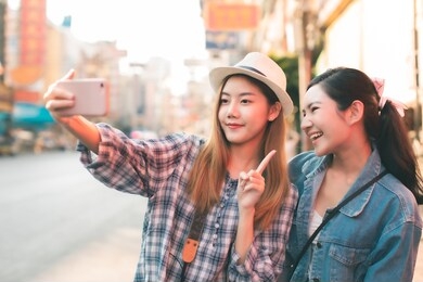 two beauty woman feel free and back to you in bangkok. selfie by mobile .