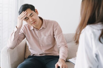 male asian patient with psychologist women examination consulting and psychotherapy by the physician in the clinic. psychiatrist concept