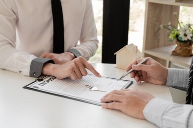 real estate agent broker with home insurance forms in order for the customer to sign the contract according to the agreement buying home insurance officially home insurance concept.