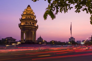 traffic drives around the independence monument in downtown phnom penh, cambodia