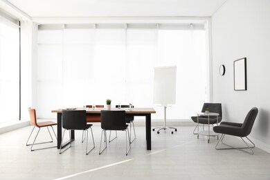 simple office interior with large table and chairs