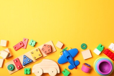 set of different children's toys on a colored background top view. a place to insert text, minimalism. baby background.
