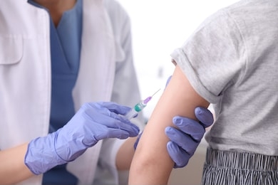 little girl receiving chickenpox vaccination in clinic, closeup. varicella virus prevention