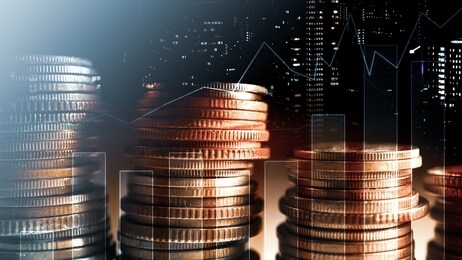 double exposure of city and rows of coins for money, finance and business concept
