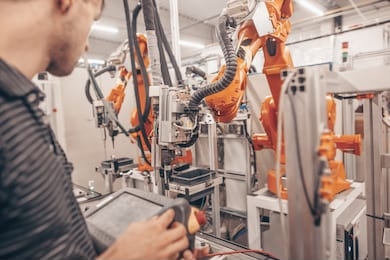 engineer, technician working with automatic robot in automotive industrial, smart factory, automated workplace