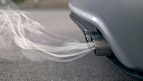 smoky exhaust pipes from a starting diesel car.