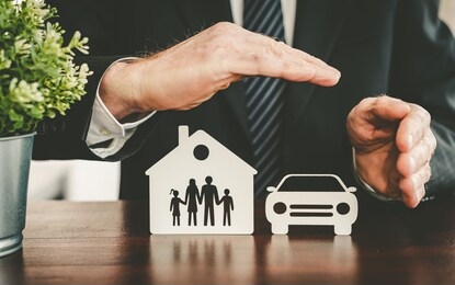family, house and car protected by hands - concept of life, home and auto insurance