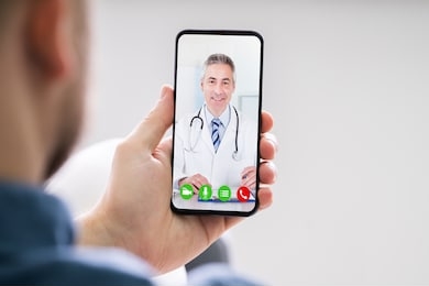 person videochatting with doctor on mobile phone