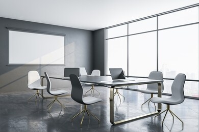 contemporary meeting room interior with blank tv screen on wall and laptop on table. business and teamwork concept. 3d rendering