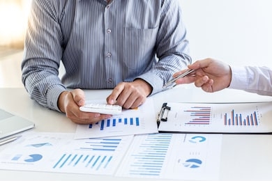 business team meeting analyze financial graphs market growth reports and corporate income tax, analysis of financial accounting and real estate investment concept.
