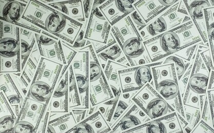 group of money stack of 100 us dollars banknotes a lot of the background texture, top view