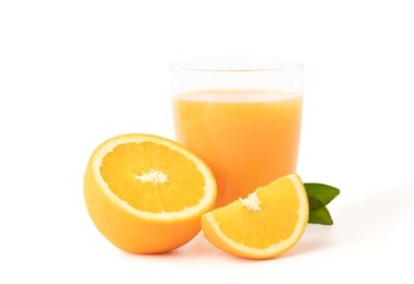glass of fresh orange juice with fruits cut in half and sliced with green leaf isolated on white background with clipping path