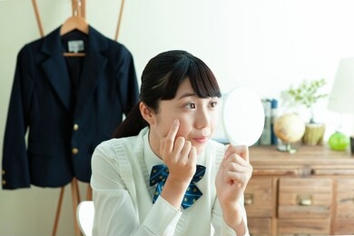 female student with a hand mirror