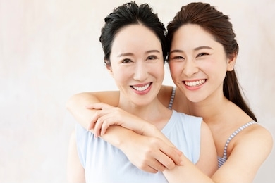 portrait of smiling mother and daughter