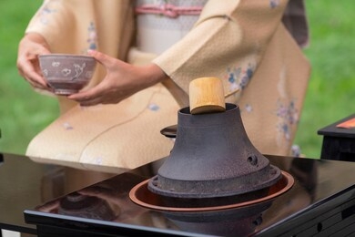 woman in kimono performs japanese tea ceremony
