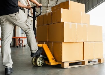 worker courier unloading shipment goods, hand pallet truck and stack package boxes on pallet, warehouse delivery service transport and logistics.