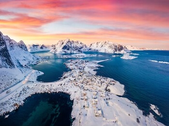 view from flying drone of reine villege. colorful sunset on popular tourist destination - lofoten island. aerial winter view of norway, europe. astonishing sescape of norwegian sea.