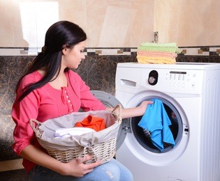 beautiful young woman erases in house