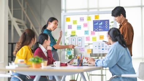 young asian woman leading business creative team in mobile application software design project. brainstorm meeting, work together, internet technology, girl power, office coworker teamwork concept