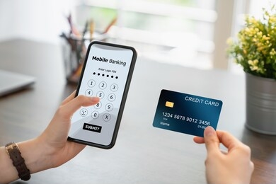woman hands using mobile banking on smartphone with holding credit card and enter password to login application.	