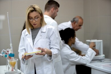 multicurtural laboratory scientist students working at lab with test tubes
