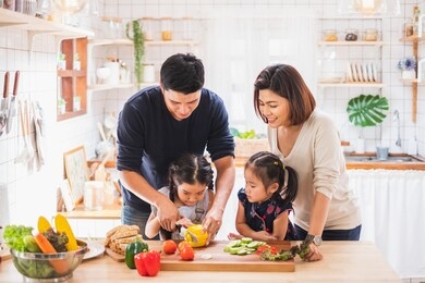 asian family enjoy playing and cooking food in kitchen at home