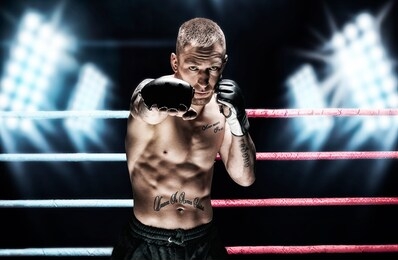mixed martial artist posing in the ring against spotlights. concept of mma, ufc, thai boxing, classic boxing. mixed media