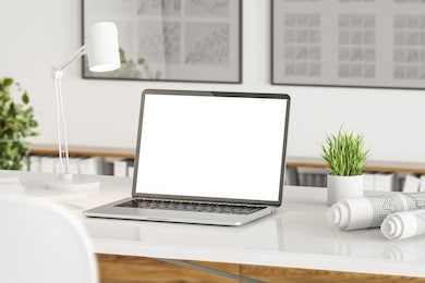 close up of mock up laptop screen standing on table in blurry office with graphs on walls and folders. concept of advertising. 3d rendering