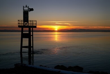            garry point strait of georgia sunset. georgia strait sunset behind the navigation aid in garry point park, steveston. 

                    