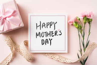 design concept - top view of bunch of beautiful carnation with handwriting calligraphy and photo frame on pink background for mother day