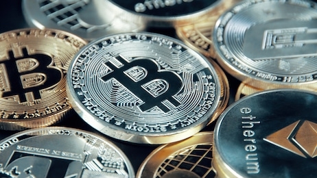 silver bitcoin coin on black background. silver crypto coin on spinning stand.