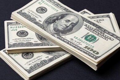 cash of hundred dollar bills, dollar background.