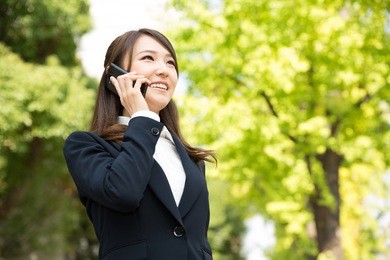 beautiful young asian woman who talks on the telephone