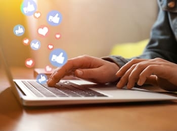 blogger working with laptop in cafe, closeup