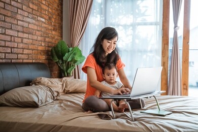 busy businesswoman working while taking care of her children at home