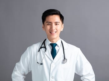 portrait of male asian young doctor on gray  background