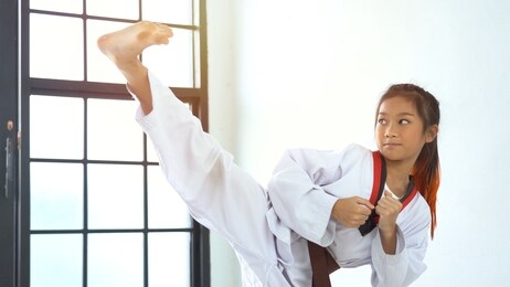 the karate girl with black belt in gym
