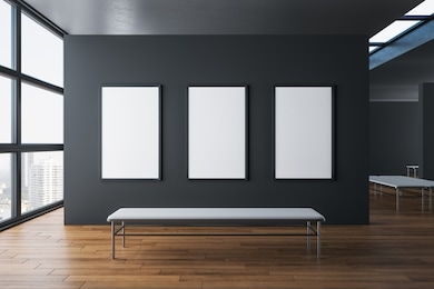 contemporary exhibition hall interior with three empty poster on concrete wall, wooden floor, city view and daylight. gallery concept. mock up, 3d rendering