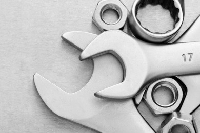 wrench tool and nut at metal  background