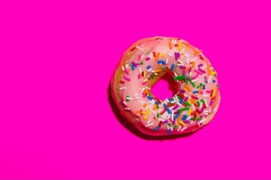sprinkle donut on hot pink background