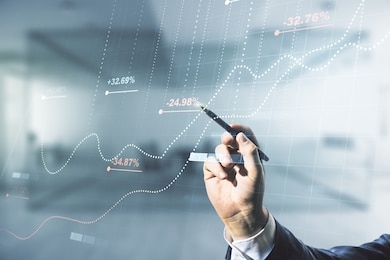 multi exposure of male hand with pen working with abstract virtual graphic data spreadsheet sketch on blurred office background, analytics and analysis concept
