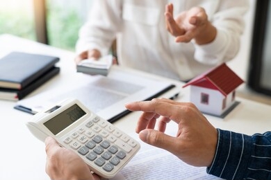 sale representative offer house purchase contract to buy a house or apartment or discussing about loans and interest rates