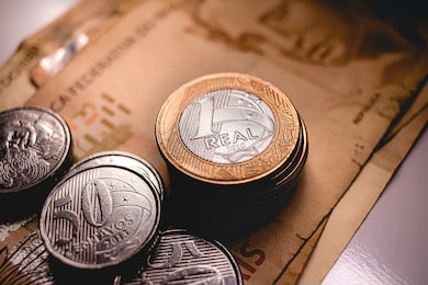 real currency - brazil. fifty reais banknotes and real coins.

