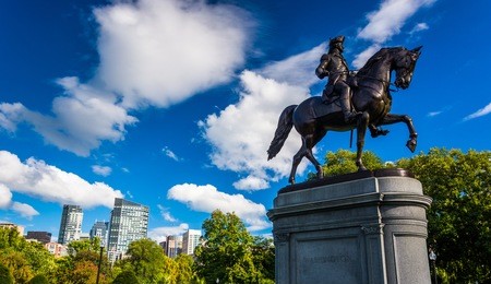 statue of george washington and the boston skyline, seen from the boston commons.