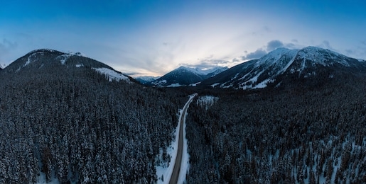 aerial panoramic view of a scenic road in the canadian mountain landscape during a cloudy springtime sunset. taken between pemberton and lillooet, bc, canada.