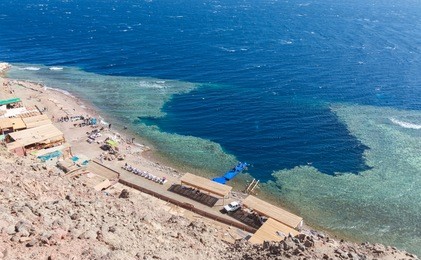 blue hole is a popular diving location on east sinai, a few kilometres north of dahab, egypt on the coast of the red sea.