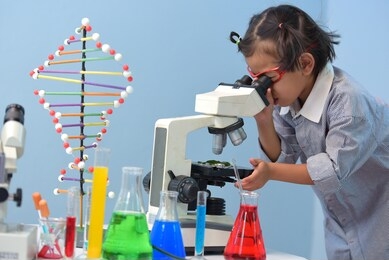 asian girls on the way to success science  in the laboratory chemical research school biology lesson the little girl in the school lab formal school education little scientists work with microscopes.