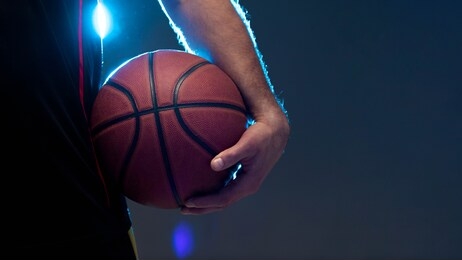 the hand of a basketball player with ball