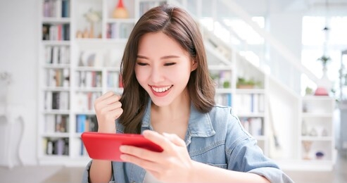 asian girl student use mobile phone to play game happily